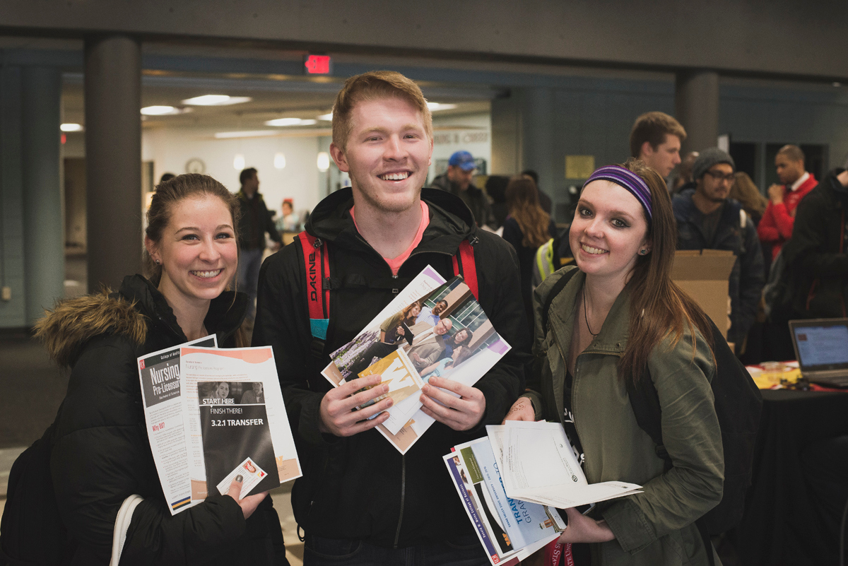 Three GRCC students holding transfer materials