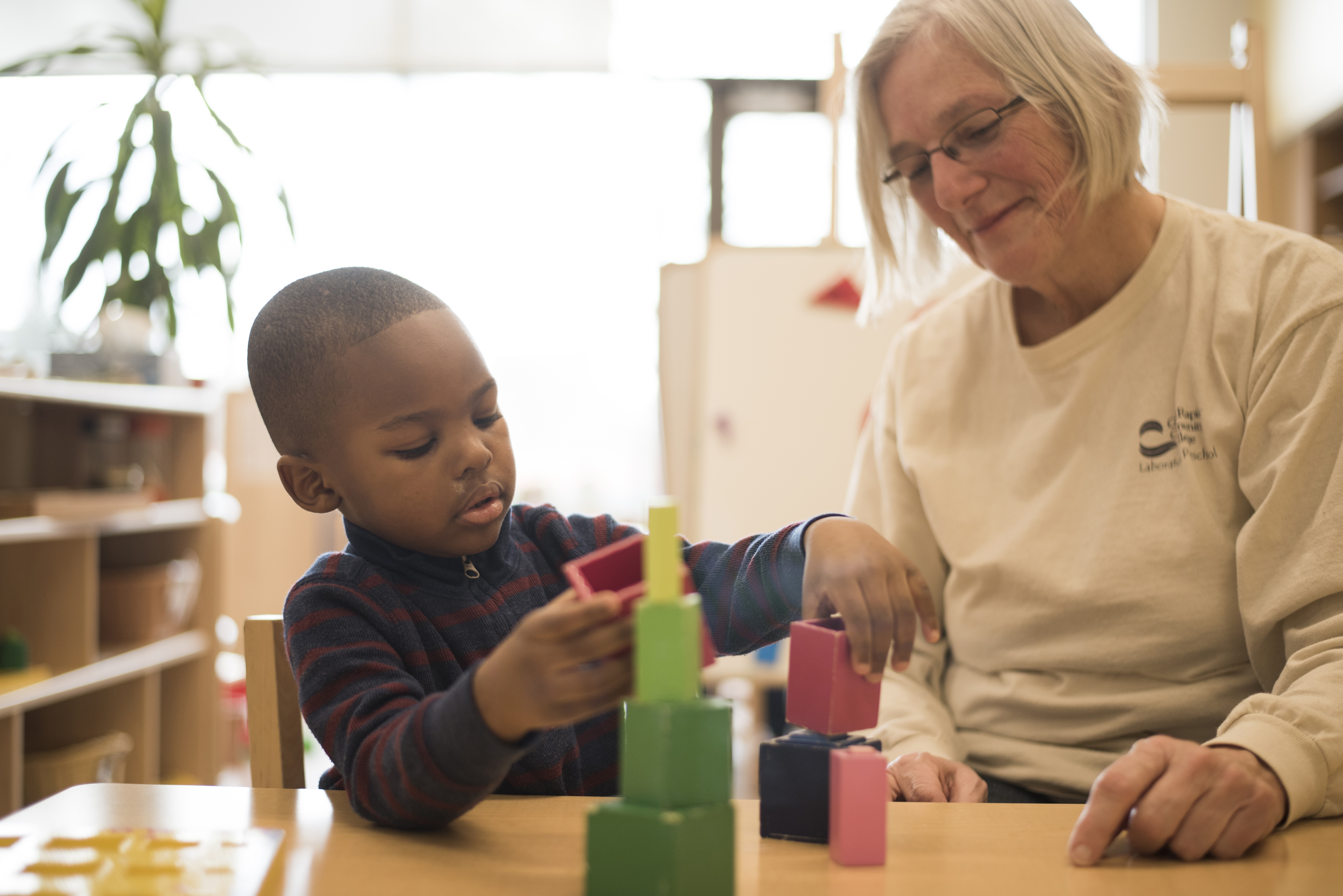 GRCC  Preschool student and faculty member playing with blocks
