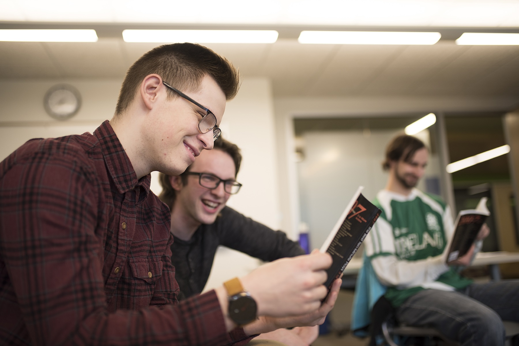 GRCC Students reviewing a book during English class