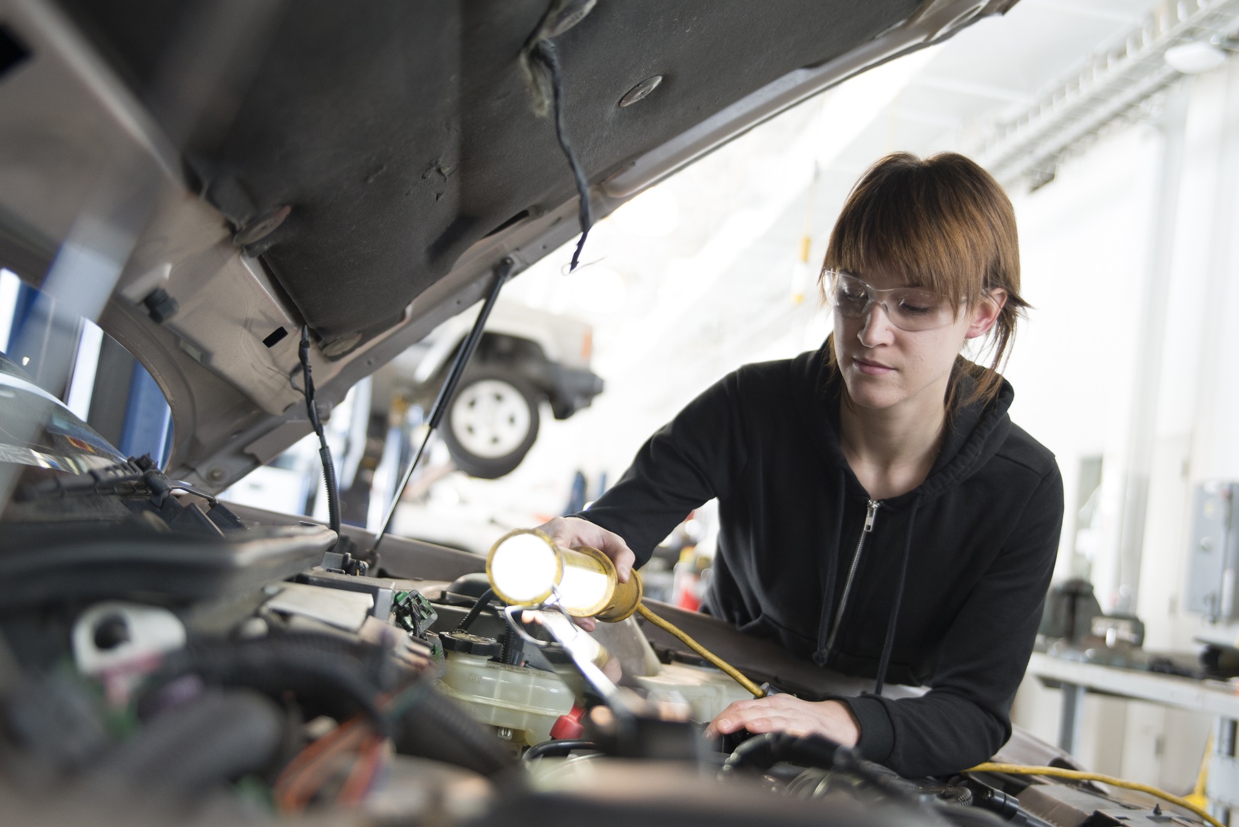 GRCC Auto Student working on the engine of a car