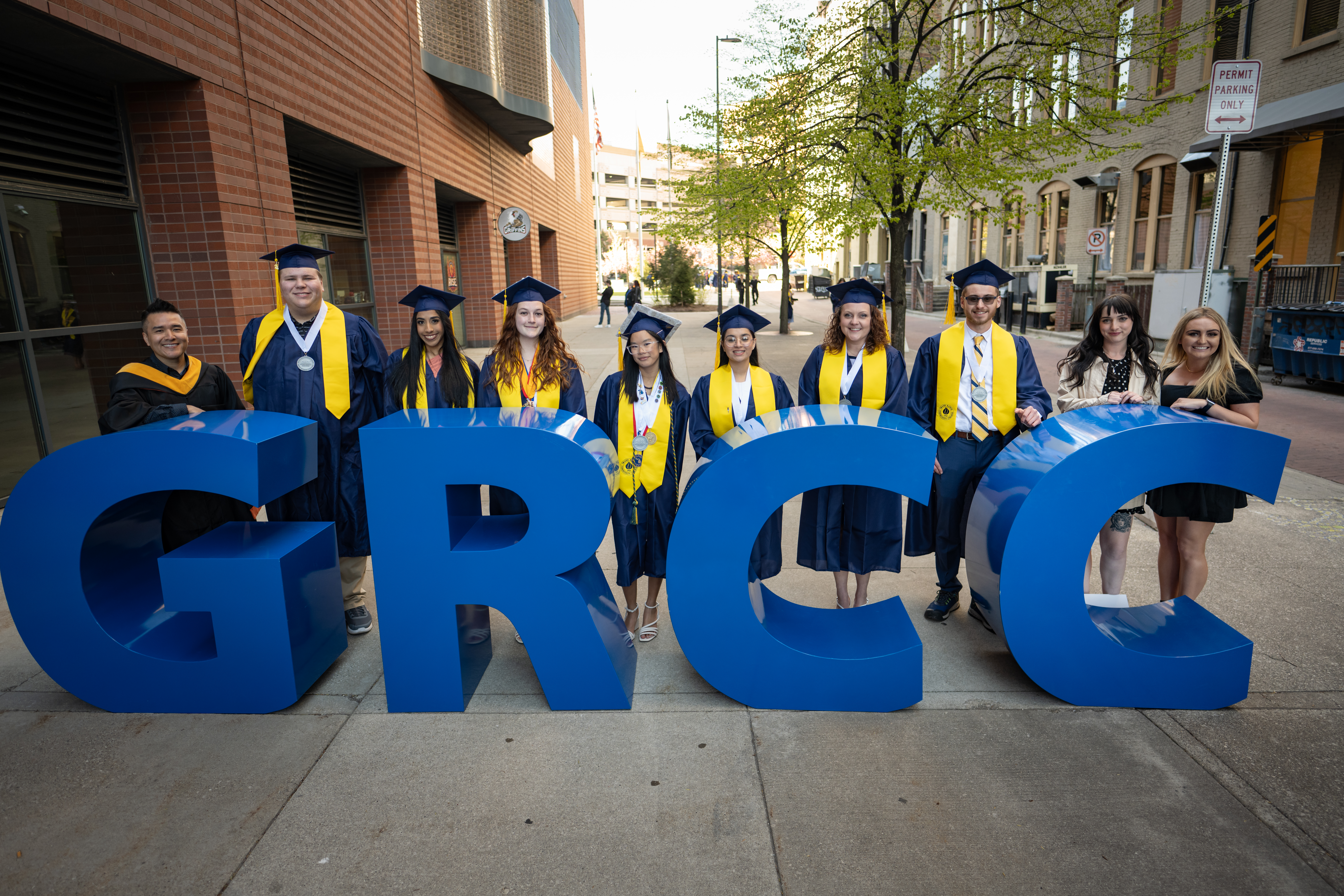 Group of GRCC Graduates in front of GRCC Letters